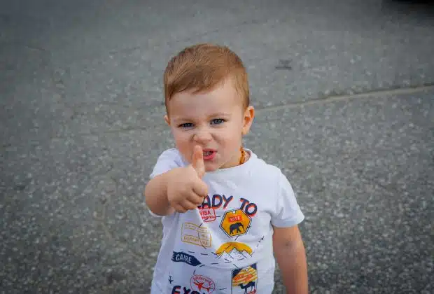 a baby with his finger in his mouth